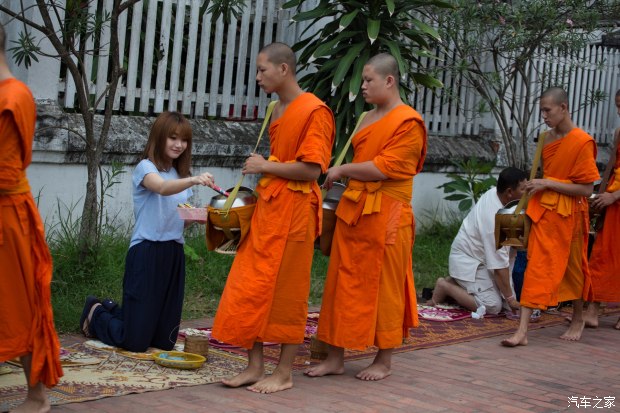 一名小和尚刚刚完成布施,放下布施来的食物之后从庙宇前经过.